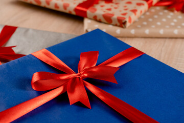 Gift box with red bow and silk ribbon for Christmas present. New Year gifts packaged in gift box...
