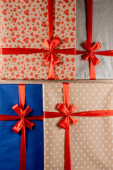 Christmas gift boxes for gifts for the new year and other winter holidays. Present with red bow and silk ribbon for the Christmas holidays.