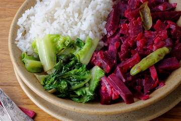 Beetroot curry with sona masoori rice and stir-fried lettuce. Asian cuisine.