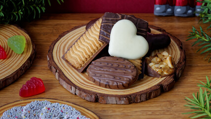Sweets heap of chocolate and cookies on a table. Winter season.