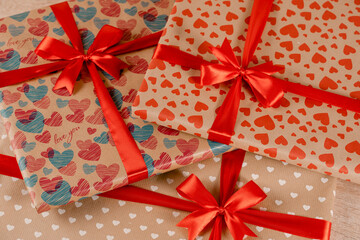 Festive packaging for birthday celebration. Gifts with a red bow for party and silk ribbon for a party.