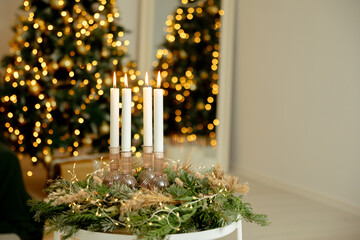 4 candles in a green wreath. Advent wreath with all 4 candles lit