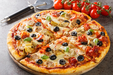 Hot homemade capricciosa pizza with aritichokes, prosciutto ham, olives, champignons and cheese...