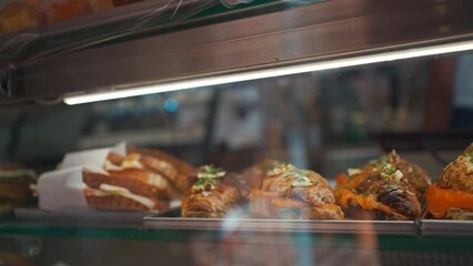 Assortment of delicious and buttery croissants with salmon on store showcase made by pastry chef. All look very tasty and delightful. Fresh croissants with sea fish