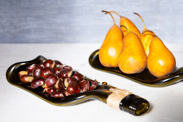 Recycled wine bottle plate with pear and edible chestnut.