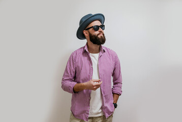 Fashion portrait of a young bearded hipster man. Handsome man in a hat isolated on white background.