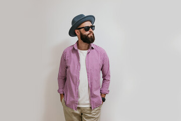 Fashion portrait of a young bearded hipster man. Handsome man in a hat isolated on white background.
