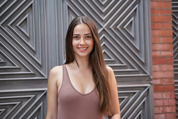 portrait of a young caucasian woman with long hair looking at the camera. smiling woman in casual clothes.