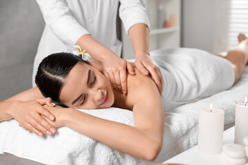 Fototapeta na wymiar Beautiful woman receiving back massage in beauty salon, closeup