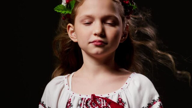 Ukrainian girl in national clothes looks at the camera. United Europe against Russia. Hope for the world. Anxiety and anticipation. Children's tears. Save Ukraine, refugees