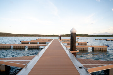 Jetty with a forest in the background during the sunset