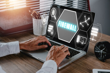 Firewall computing security concept, Person using laptop computer with Firewall icon on virtual...