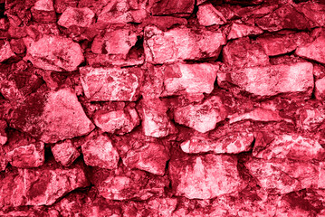 Grunge old brick wall as background toning in color 2023 Viva Magenta