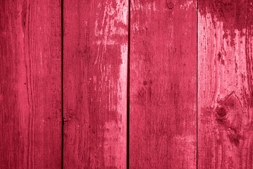 Vintage wooden background with peeling red paint. Trendy Viva Magenta Color of the Year 202