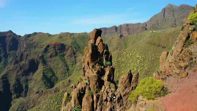 High volcanic green mountains form a huge gorge in Teno national park Masca village. Hiking area. Tourist attraction. Aerial cinematic flight. Tenerife Canary Islands Spain Europe.