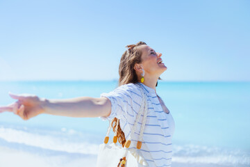 happy elegant woman at beach rejoicing