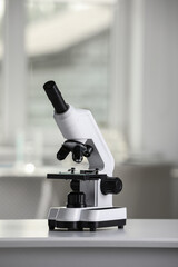 Modern medical microscope on white table in laboratory