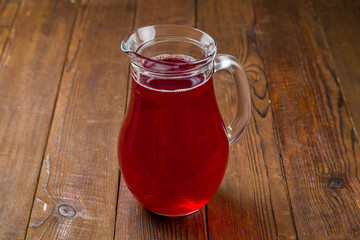 red compote on wooden table side view