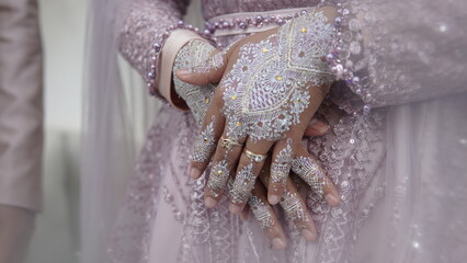 close-up of beautiful woman with henna tattoo on her hand. Beautiful Bridal Hands with henna and...