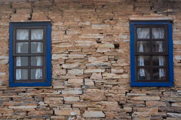Two old windows on a wall made of stones in the city of São Tomé das Letras, in State of Minas Gerais, Brazil.