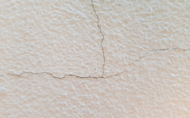 Close-up photo of a cracked house wall.