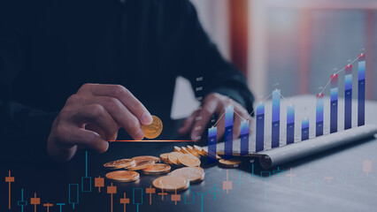 investment and finance concept, businessman holding fake gold coin and working with trading graph...