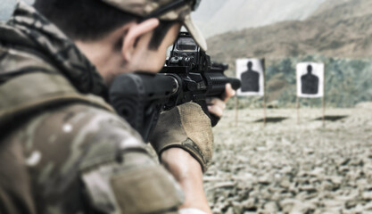 Military soldier shooter aim assault rifle weapon at outdoor academy shooting range