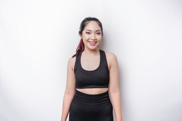 A portrait of a sporty Asian woman wearing a sportswear isolated by white background