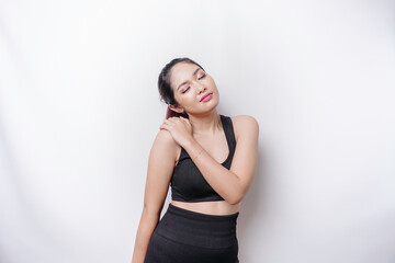 Naklejka premium Tired upset young sporty woman suffering from pain, muscle spasm at gym. Fatigue, pain and incorrect posture