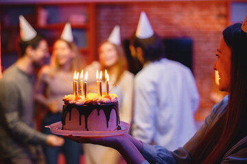 Cropped photo of a plate with birthday cake in woman's hands