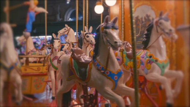 A colourful Carousel with lights and horses on a evening
