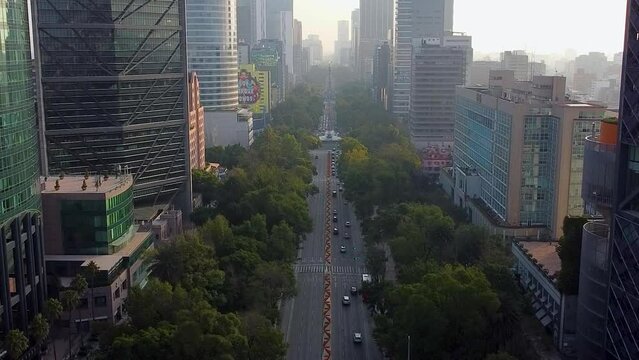 aerial view of Paseo de La Reforma avenue, landmark in Mexico City, sky with sun and clouds