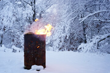 Fire barrel burning garbage during the winter.