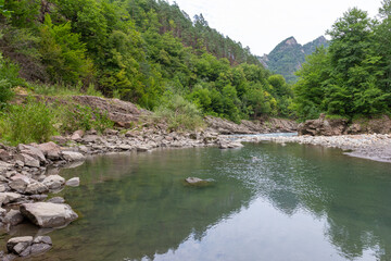the beginning of autumn, a mountain river with rapids and whirlpools, a panoramic view of the mountains, hiking trails and recreation in the mountains.*
