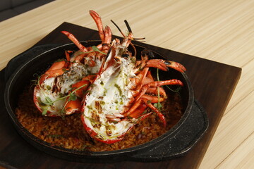 Roasted lobster on top of seafood paella