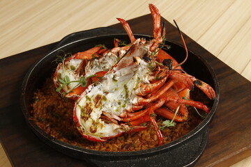 Roasted lobster on top of seafood paella