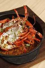 Roasted lobster on top of seafood paella