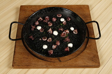 Paella negra—black rice with squid and aioli sauce, a dish from Spain and the Philippines