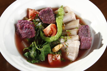 Pork sinigang with ube, a soup from the Philippines made from pork, varous vegetables and tamarind-based soup