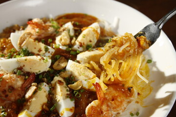 Pancit palabok, a noodle dish from the Philippines made from thin noodles called bihon, shrimp, hardboiled eggs, pork cracklings, and shrimp gravy