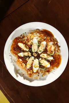 Pancit palabok, a noodle dish from the Philippines made from thin noodles called bihon, shrimp, hardboiled eggs, pork cracklings, and shrimp gravy