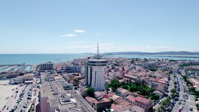 Aerial shot of Palavas Lighthouse in Grande Motte Town with beautiful harbor and blue seascape in summer - France,Europe