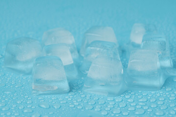 ice cubes with water drops close-up on a blue background