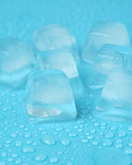 ice cubes with water drops close-up on a blue background