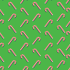 Red and white lollipops on green background. Christmas pattern. Seamless pattern.