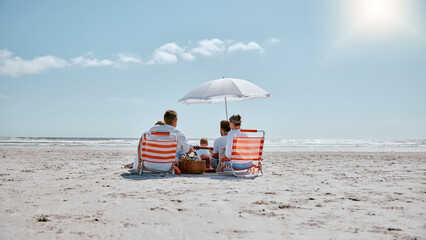 Family, relax and picnic in the sun on the beach for summer vacation, holiday or weekend getaway in...