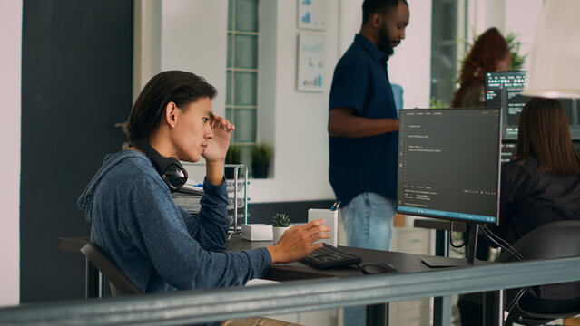 System engineer working with html script on terminal window, looking at computer screen and typing. Software developer in it office writing innovating ai algorithm and system programming.