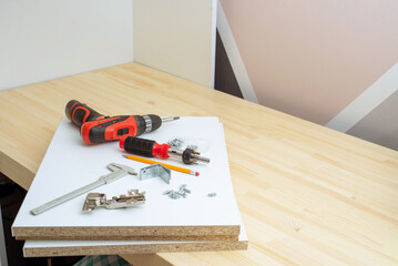furniture assembly - worker installing cabinet shelf