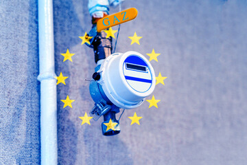 gas meter and the flag of the European Union, a symbol of expensive energy resources, a limited...