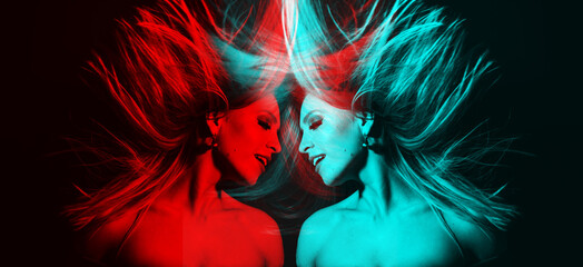 Fashion concept. Portrait of beautiful woman with flying hair in red and blue color split effect style. Futuristic looking style. Image contains motion blur. Model with happy facial expression